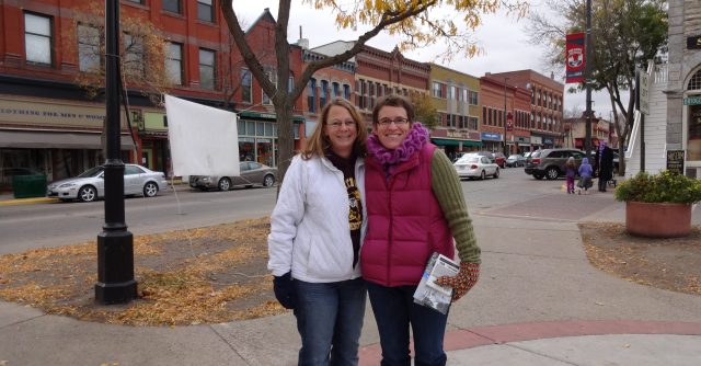 "Downtown Northfield with two United Way representatives holding brochures"
