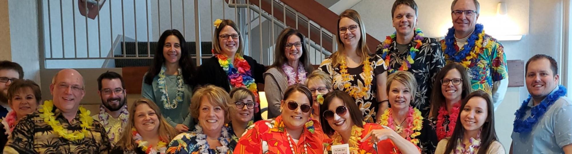 Community Resource Bank staff celebrate Hawaiin day of their United Way campaign - wearing tropical shirts and colorful leis