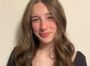 Annie looking at the camera wearing a black shirt