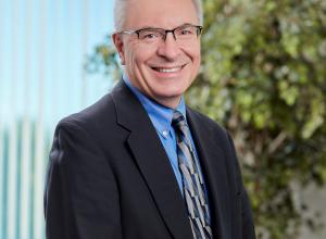 Peter wearing a tie and smiling at camera
