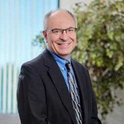 Peter wearing a tie and smiling at camera