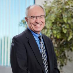 Peter wearing a tie and smiling at camera